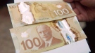 The $100 bill is shown in Toronto, on Monday Nov. 14, 2011. (THE CANADIAN PRESS/Nathan Denette)