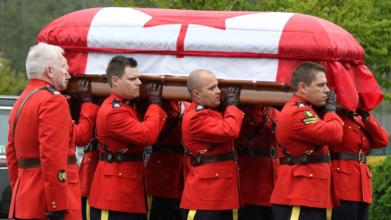 RCMP pallbearers carry the casket of Const. Sarah Beckett during a regimental funeral service at the Q Centre arena in Colwood, B.C., Tuesday, April 12, 2016. (Chad Hipolito/The Canadian Press)