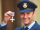 Royal Air Force Chinook pilot Flight Lieutenant Christopher Hasler stands outside Buckingham Palace, London, on May 23, 2007 after collecting his Distinguished Flying Cross from Queen Elizabeth II. (AP / Fiona Hanson)