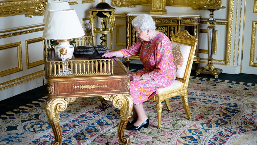 Queen Elizabeth II tweeting on a tablet