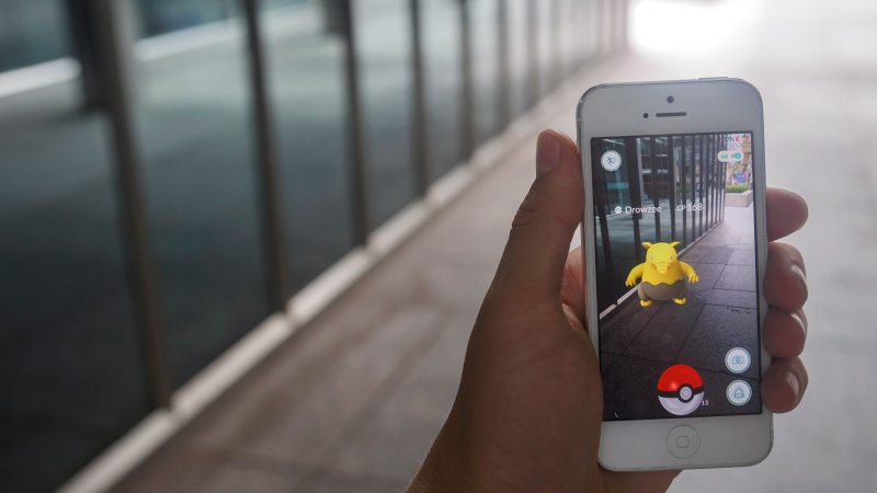 A Pokemon appears on a smartphone playing Pokemon Go in downtown Toronto, Ontario on Tuesday, July 19, 2016. (THE CANADIAN PRESS/Cole Burston)