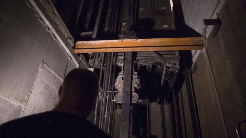 A building manager is pictured in an elevator pit in a downtown Toronto office building on on July 13, 2016. (THE CANADIAN PRESS)