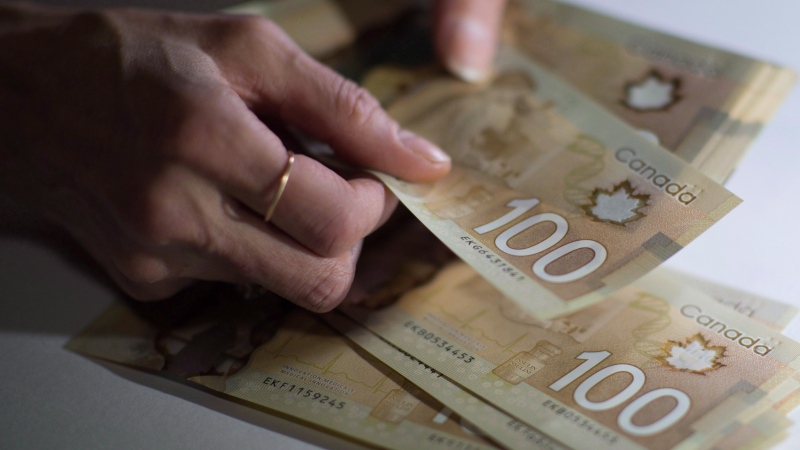 Canadian $100 bills are counted in Toronto on Feb. 2, 2016. (THE CANADIAN PRESS/Graeme Roy)