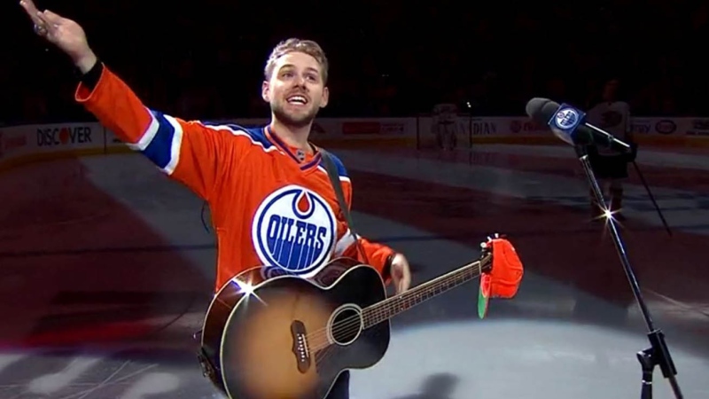 Kissel attempted twice to sing the anthem before throwing his hands in the air and encouraging the crowd to sing with him. (Edmonton Oilers via Twitter)