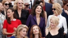 Juliette Binoche, centre, laughs, as she stands behind Catherine Deneuve, Isabelle Huppert, and Nicole Kidman as actors and directors from former Cannes selections pose for photographers during the photo call for the 70th Anniversary of the international film festival, Cannes, southern France, Tuesday, May 23, 2017. (AP / Thibault Camus)
