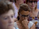 People observe a minute of silence in memory of the terror attack victims in Cambrils, Spain, Friday, Aug. 18, 2017. (AP Photo/Emilio Morenatti)