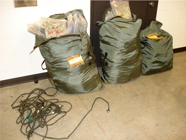 Led to an area by suspicious activity, U.S. border agents discovered three large duffel bags filled with individually wrapped packages of marijuana near the Sumas Station. (U.S. Customs and Border Protection)