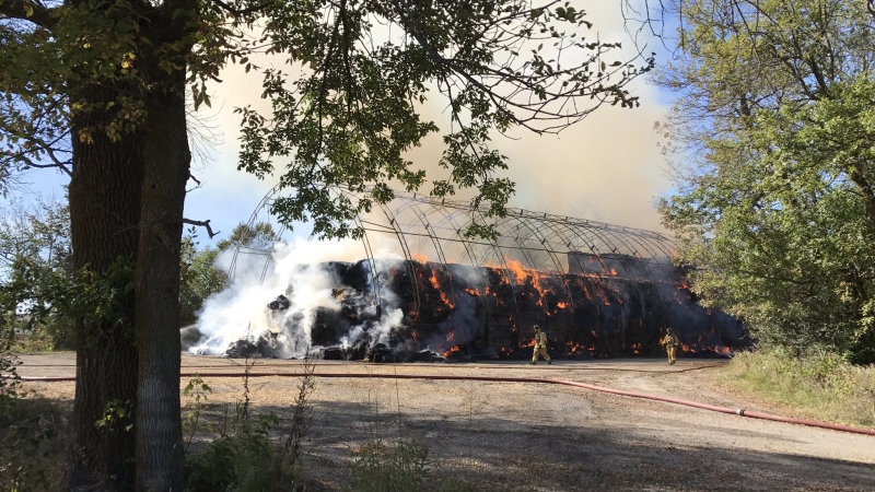 Ottawa Fire says a barn, that had held roughly 1,000 bales of hay, will need to be demolished, after a fire erupted Monday afternoon. (Todd Horricks/Ottawa Fire Services)