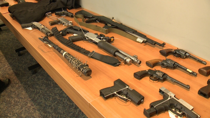 Some of the firearms and weapons seized by Ottawa Police during Project Sabotage are displayed on a table during a media conference on Friday, Dec. 15, 2017. (CTV Ottawa)