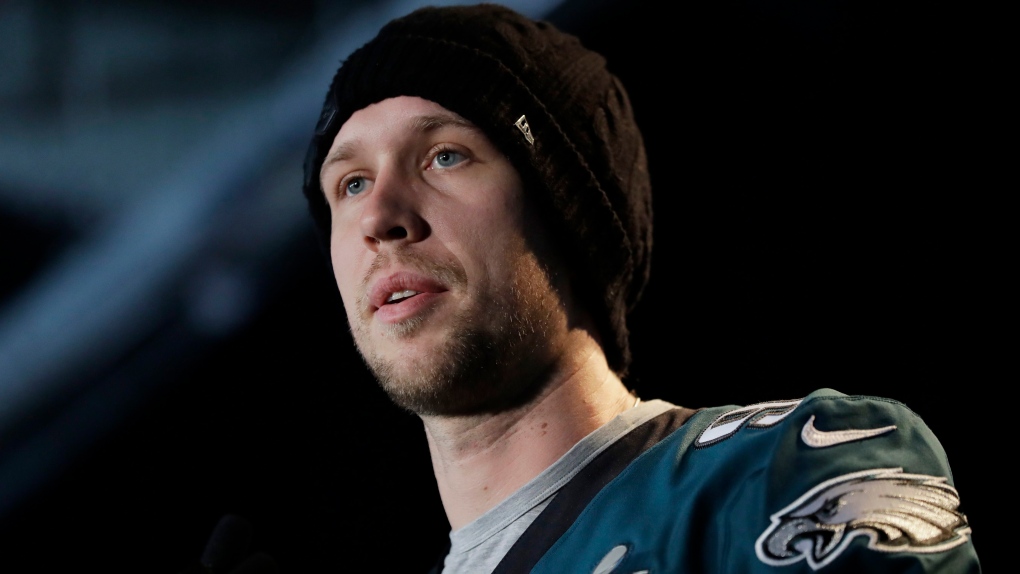 Eagles quarterback NICK FOLES raises the Lombardi Trophy