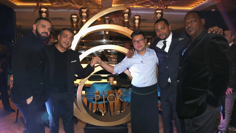 Drake, (L) and chef Antonio Park (center, in white) at Pick 6IX. (Courtesy of Pick 6IX restaurant)