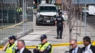 Police are seen near a damaged van in Toronto after a van mounted a sidewalk crashing into a number of pedestrians on Monday, April 23, 2018. (THE CANADIAN PRESS/Aaron Vincent Elkaim)