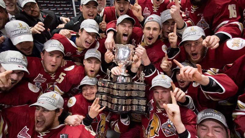 Members of the Acadie-Bathurst Titan pose with the Memorial Cup after defeating the Regina Pats in the Memorial Cup final in Regina on Sunday, May 27, 2018. THE CANADIAN PRESS/Jonathan Hayward