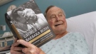 This photo provided by Office of George H. W. Bush shows a photo of former President George H.W. Bush that has tweeted on Friday, June 1, 2018 from his hospital bed while reading a book about himself and his late wife in Biddeford, Maine. (Paul Morse/Office of George H. W. Bush via AP)