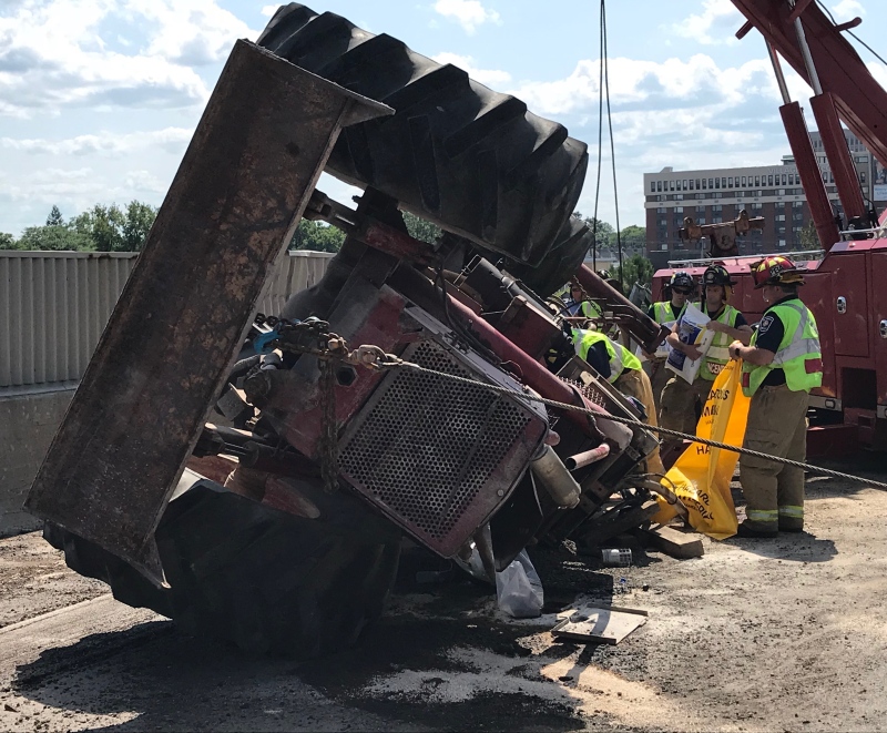 A tractor trailer overturned on the Queensway early Thursday afternoon near Metcalfe Street. No one was injured. (Ottawa Fire Services)