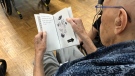 A senior reads a "dementia-friendly" picture book from Marlena Books. (Marlena Books)