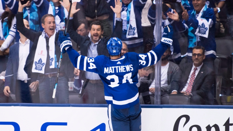 Toronto Maple Leafs centre Auston Matthews (34) celebrates the game winning goal with fans during overtime NHL hockey action against the Montreal Canadiens in Toronto on Wednesday, October 3, 2018. (THE CANADIAN PRESS/Nathan Denette)