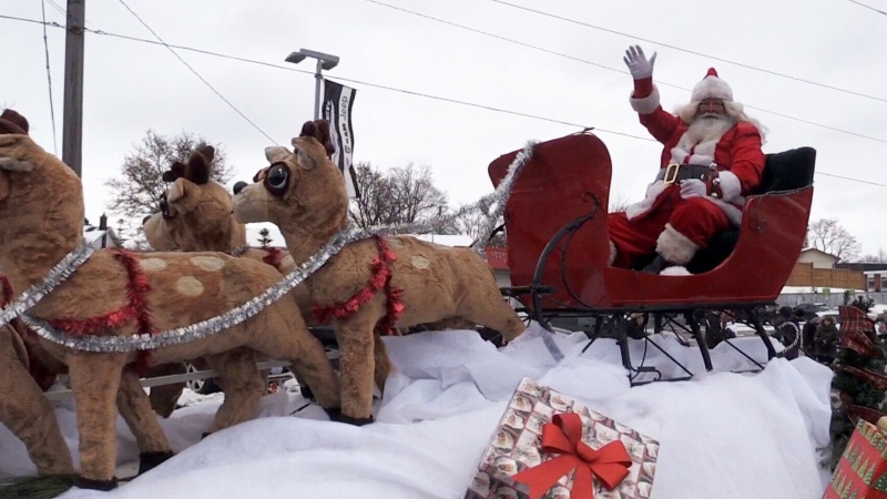 Santa Claus waves to the crowd during Kitchener's Santa Claus parade on Saturday.