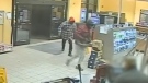 This image taken from YouTube video shows two suspects sought in a robbery in Windsor, Ont. on Tuesday, Nov. 27, 2018. (Windsor Police / YouTube)
