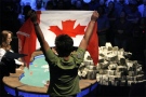 Professional poker player Tuan Lam of Mississauga, Ont. holds a Canadian flag at the final table of the World Series of Poker at the Rio hotel-casino in Las Vegas on Wednesday, July 18, 2007.  (AP / Jae C. Hong)