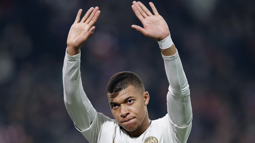 PSG's Kylian Mbappe waves to supporters