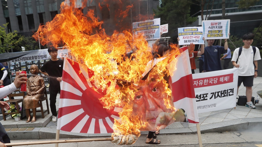 South Korean students burn a banner in Seoul