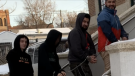 Shawn Alexander Kelly (far left), Seyed Kourosh Miralinaghi (second farthest right), and Seyed Kamran Miralinaghi (farthest right) enter Swift Current Provincial Court to address their human trafficking charges Friday. (Courtesy: Swift Current Online)