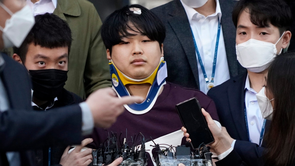 Cho Ju-bin walks out of a police station in Seoul