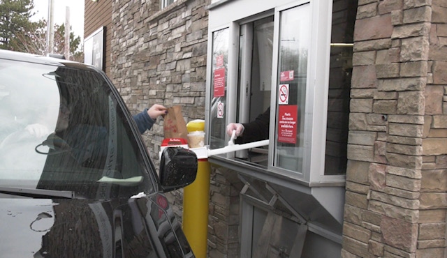 Cleanstix, a long handle with tray, is used at the Tim Hortons drive-thru in Collingwood, Ont., on Tues., April 14, 2020. (Roger Klein/CTV News)