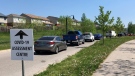 Vehicles line up at the COVID-19 assessment centre at the Carling Heights Optimist Community Centre in London, Ont. on Tuesday, May 26, 2020. (Jim Knight / CTV London)