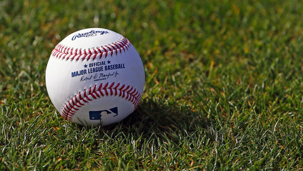 An official MLB baseball on the grass 