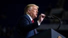 U.S. President Donald Trump speaks during a campaign rally at the BOK Center, Saturday, June 20, 2020, in Tulsa, Okla. White House trade adviser Peter Navarro claimed Sunday that U.S. President Donald Trump was being "tongue in cheek" when Trump revealed at a campaign rally that he's told officials in his administration to slow down coronavirus testing because of the rising number of cases in America. (Evan Vucci/AP)