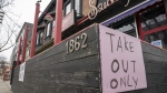 A restaurant in Toronto displays a "Take Out Only" sign on Wednesday, March 18, 2020. Ontario's two most heavily populated regions will see more businesses open their doors today as Toronto and Peel move into the next stage of the province's COVID-19 recovery plan. THE CANADIAN PRESS/Frank Gunn