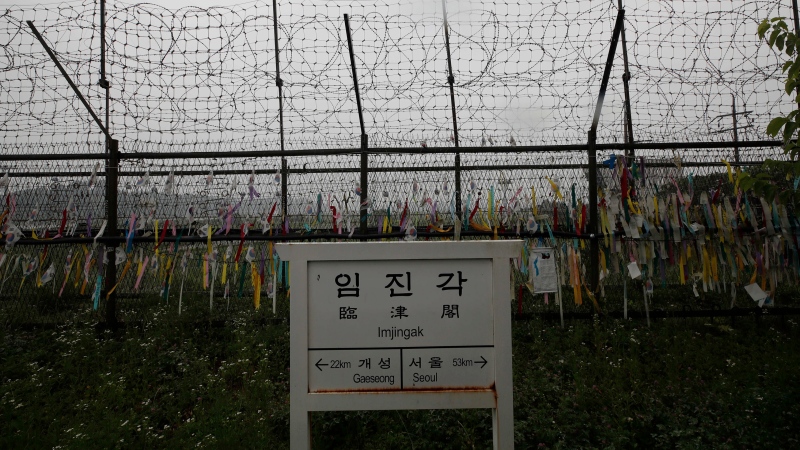 A directional sign showing the distance to North Korea's Kaesong city and South Korea's capital Seoul is seen near the wire fences decorated with ribbons written with messages wishing for the reunification of the two Koreas at the Imjingak Pavilion in Paju, South Korea, Wednesday, June 24, 2020. (AP Photo/Lee Jin-man)