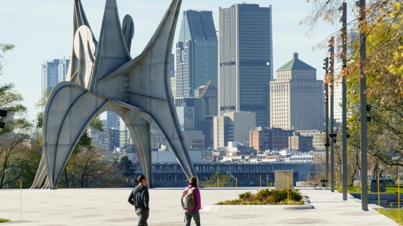 A couple walk on the site of Expo 67 on a warm fall day in Montreal, on Thursday, November 5, 2020. THE CANADIAN PRESS/Paul Chiasson
