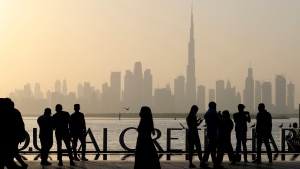 People enjoy their weekend with the view of city skyline and the world tallest tower, Burj Khalifa, in Dubai, United Arab Emirates, Friday, Jan.29, 2021. (AP Photo/Kamran Jebreili)