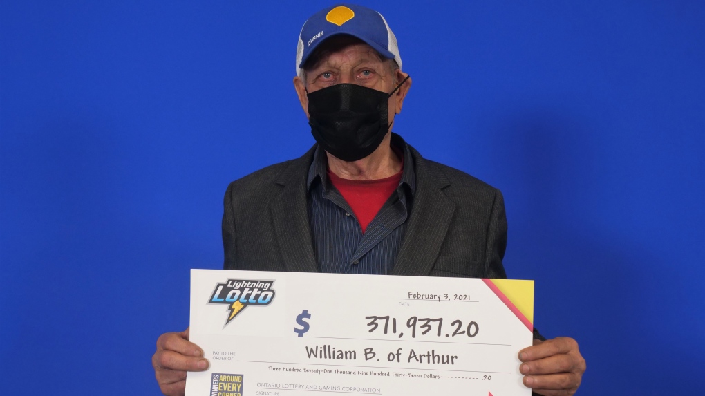 man posing with a large cheque