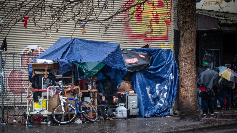 FILE: A shelter of umbrellas and tarps is seen in Vancouver's Downtown Eastside on Dec.13, 2020. (Darryl Dyck / THE CANADIAN PRESS)
