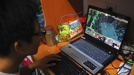 In this photo taken on Oct. 12, 2009, a college student plays the online game World of Warcraft in his dormitory room in southwest China's Chongqing city. (AP Photo)