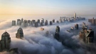 In Oct. 5, 2015 file photo, a thick blanket of early morning fog partially shrouds the skyscrapers of the Marina and Jumeirah Lake Towers districts of Dubai, United Arab Emirates. Police in Dubai arrested a group of people on charges of public debauchery, authorities said Saturday, April 3, 2021, over a widely shared video that showed naked women posing on a balcony in the Marina. (AP Photo/Kamran Jebreili, File)