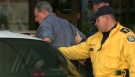 Toronto Humane Society president Kim Trow is taken into police custody during the raid, Thursday, Nov. 26, 2009.