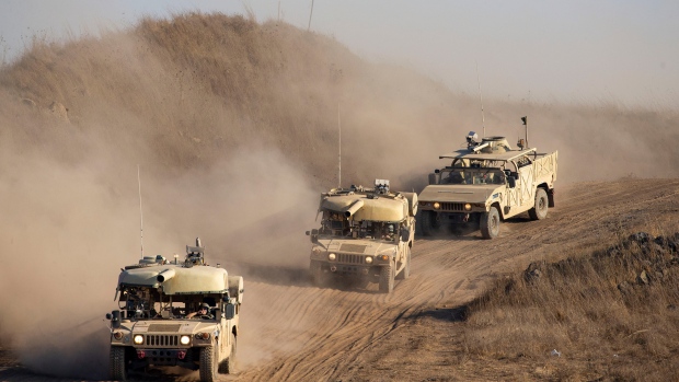 Israeli soldiers drive military vehicles during an exercise in the Israeli controlled Golan Heights near the border with Syria, Tuesday, Aug. 4, 2020. (AP Photo/Ariel Schalit)