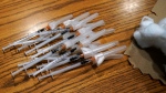 Prepared Pfizer COVID-19 vaccine syringes for children ages 5 to 11 laid out on a table at London Middle School during a vaccination clinic in Wheeling, Ill., Wednesday, Nov. 17, 2021. (AP Photo/Nam Y. Huh) 
