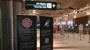 Reminders of the vaccine requirement are pictured in Winnipeg’s James Richardson International Airport on Dec. 1, 2021. (Source: Josh Crabb/ CTV News Winnipeg)