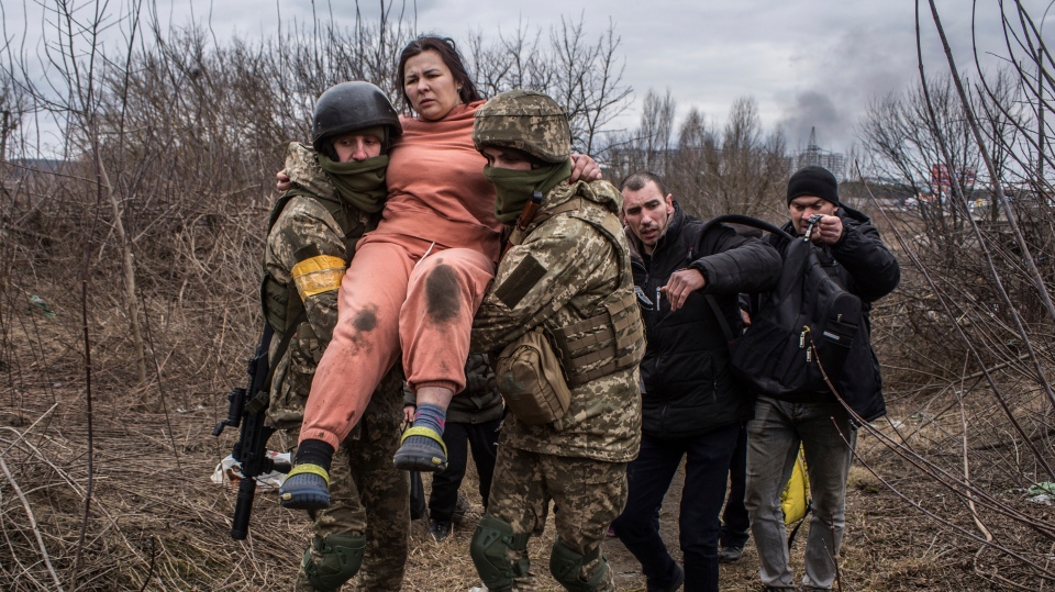 Ukraine soldiers carry woman