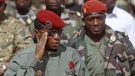 Guinea military leader Capt. Moussa Dadis Camara, left, salutes next to his aide Abubakar Diakite during independence day celebrations in Conakry, Guinea, in this file photo taken Friday, Oct. 2, 2009. (AP / Schalk van Zuydam, File)
