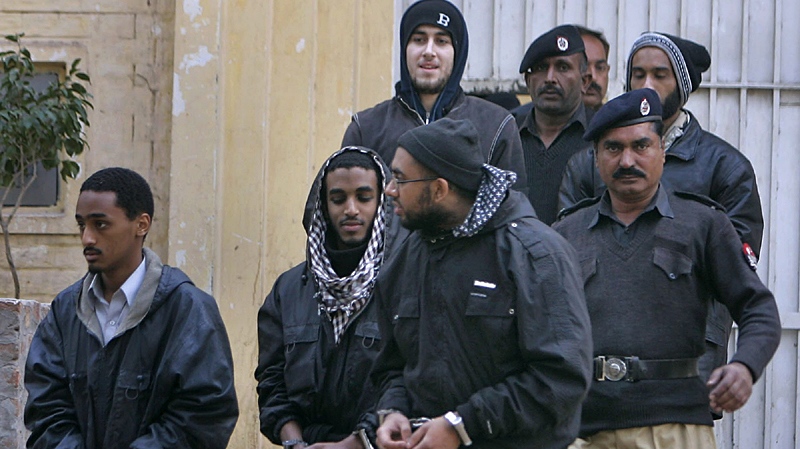 Pakistani police officers with detained American Muslims leave a police station to send them into prison in Sargodha, Pakistan, Monday, Jan. 4, 2010. (AP / K.M. Chaudary)