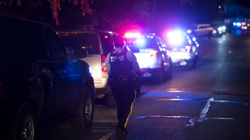 A member of the RCMP arrives on scene of a call in Surrey, B.C., Friday, May 31, 2019. THE CANADIAN PRESS/Jonathan Hayward