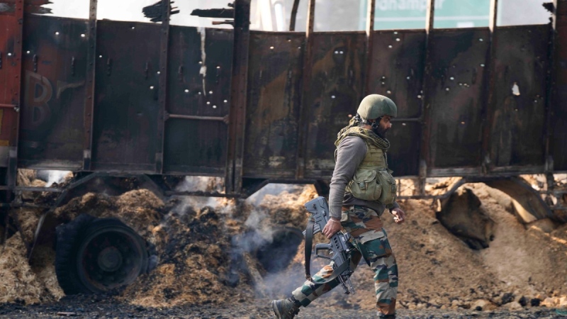 An Indian army soldier walks past the site of a gunfight at Nagrota, on the Jammu-Srinagar highway, Indian-controlled Kashmir, Dec. 28, 2022. (AP Photo/Channi Anand)
