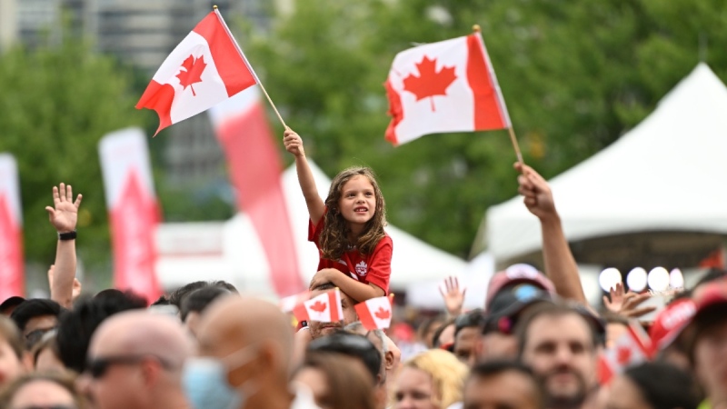 A child waves the Maple Leaf flag during Canada Day celebrations at LeBreton Flats in Ottawa, July 1, 2022. THE CANADIAN PRESS/Justin Tang